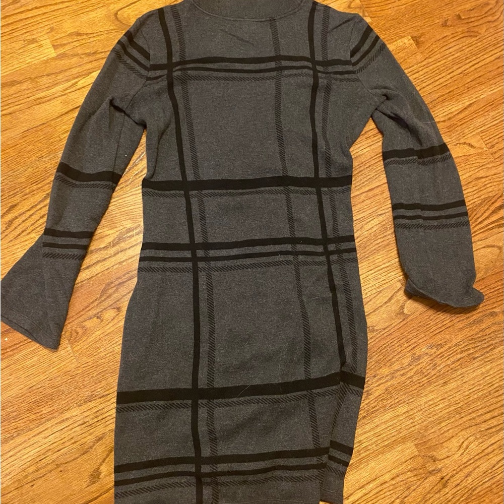 Black striped dress with flared sleeves.